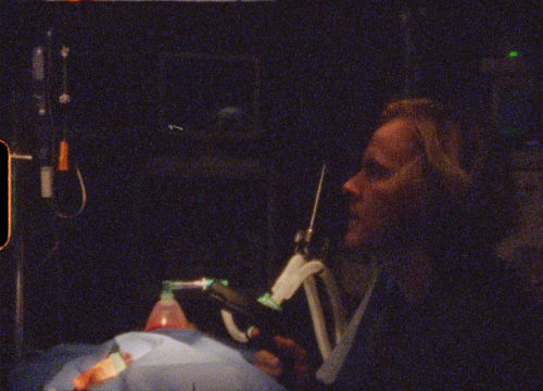 Courier kneeling by opersting table